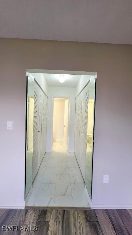 corridor with marble finish floor