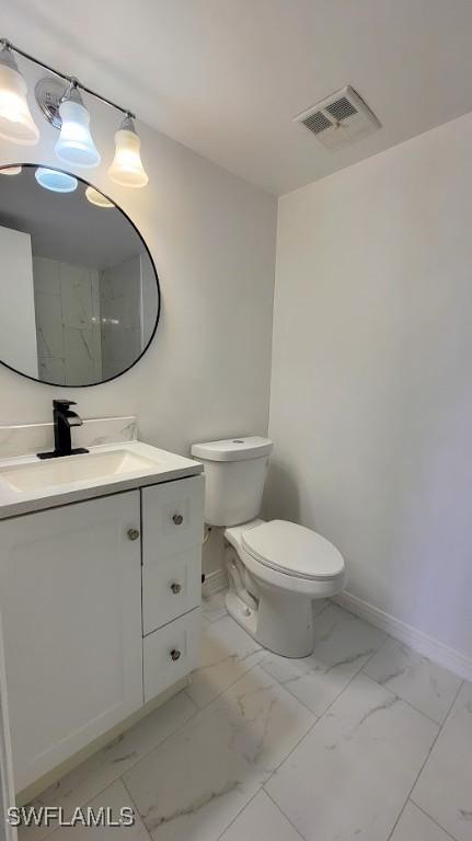 bathroom with toilet, vanity, visible vents, baseboards, and marble finish floor