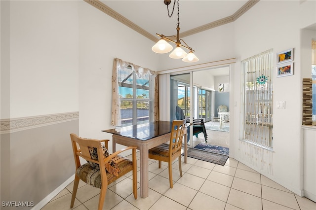 dining area with light tile patterned floors, baseboards, and crown molding