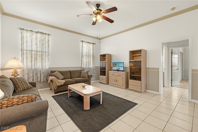 living room with light tile patterned floors, ornamental molding, and a ceiling fan