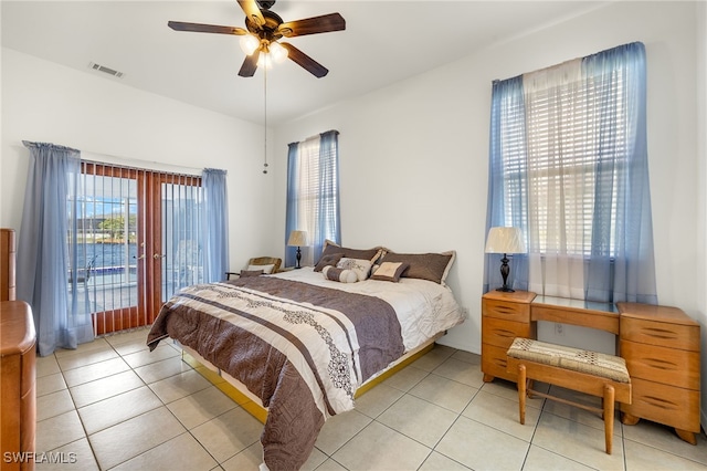 bedroom featuring a ceiling fan, light tile patterned flooring, visible vents, and access to exterior