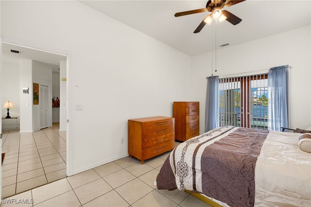 bedroom featuring a ceiling fan, visible vents, baseboards, and light tile patterned floors