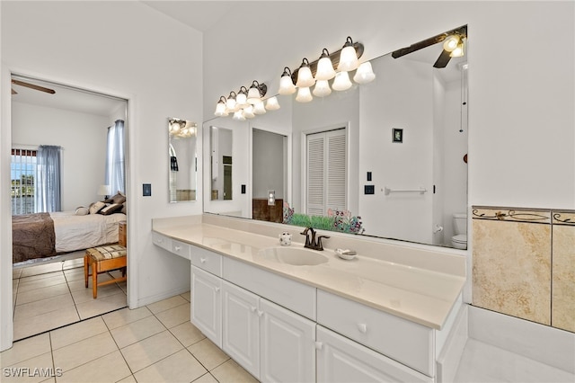 full bathroom featuring toilet, tile patterned flooring, connected bathroom, and a ceiling fan