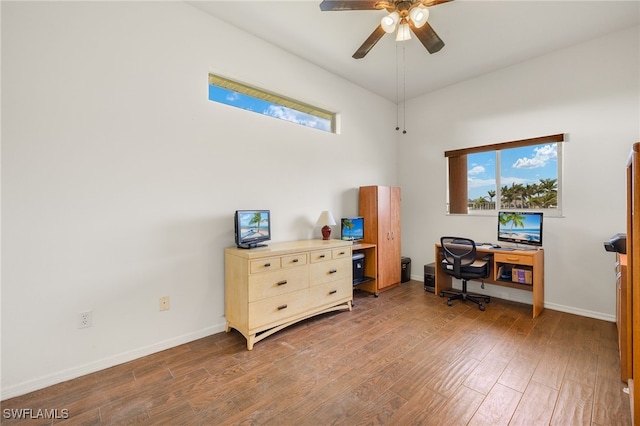 office space with a wealth of natural light, baseboards, and wood finished floors