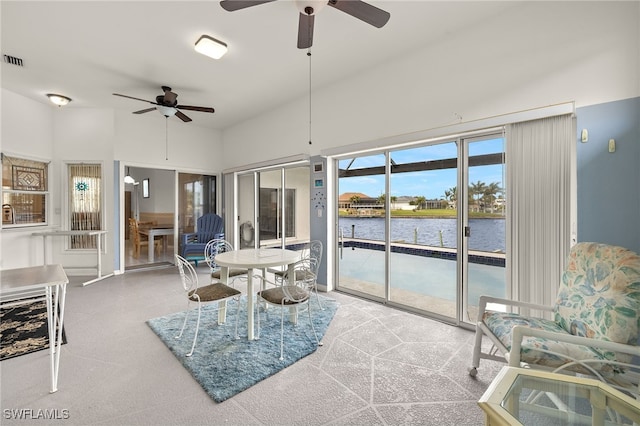 sunroom / solarium featuring a water view and visible vents