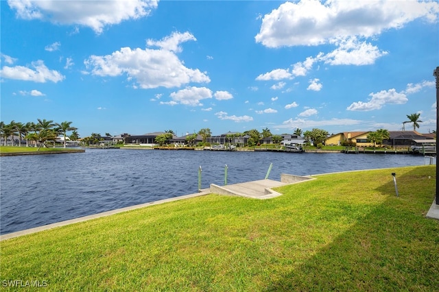 view of dock featuring a residential view, a water view, and a lawn