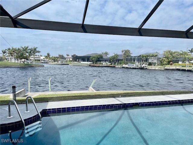 view of swimming pool featuring a water view and a lanai