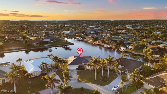 birds eye view of property with a water view and a residential view