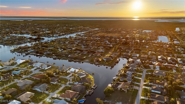 birds eye view of property with a residential view and a water view