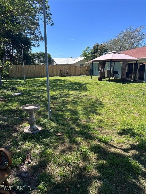 view of yard featuring a gazebo and fence