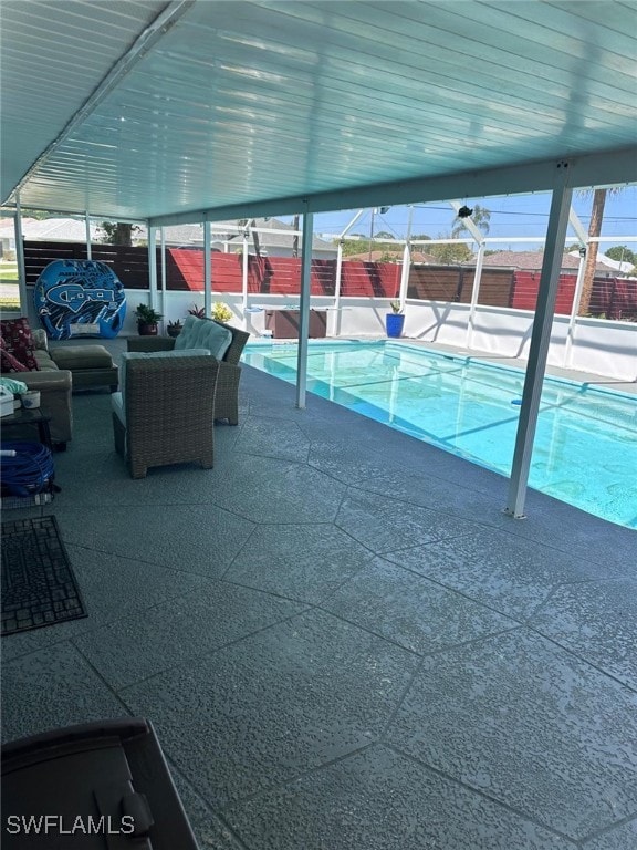 view of swimming pool with a fenced backyard, a fenced in pool, an outdoor hangout area, a lanai, and a patio area