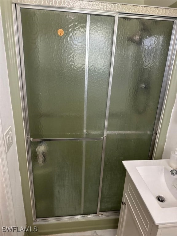 bathroom featuring vanity and a shower stall