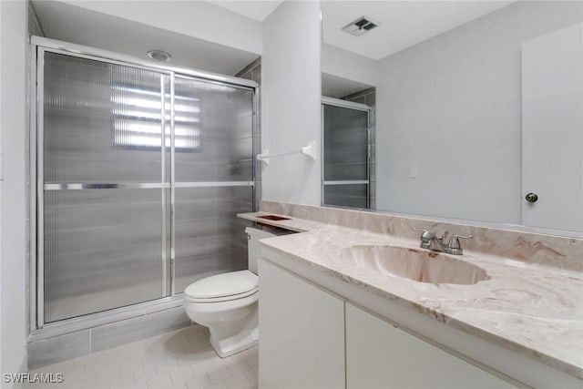 full bathroom featuring visible vents, toilet, a stall shower, tile patterned floors, and vanity