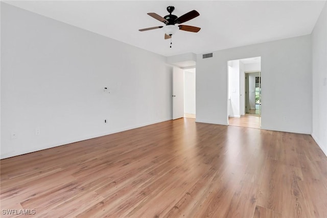 unfurnished room featuring visible vents, light wood-type flooring, and a ceiling fan