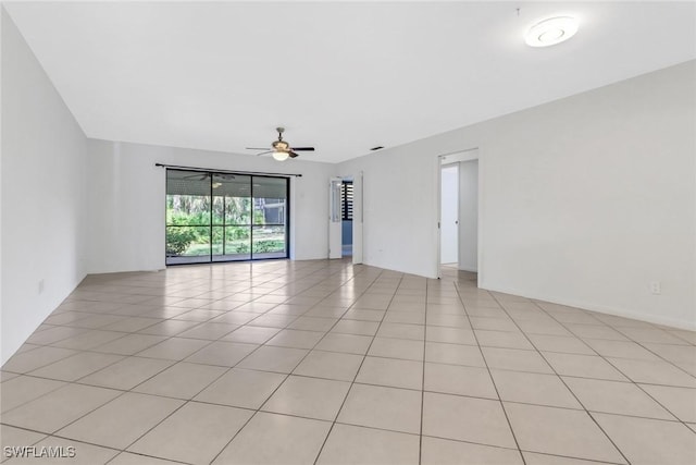 spare room featuring light tile patterned flooring and a ceiling fan