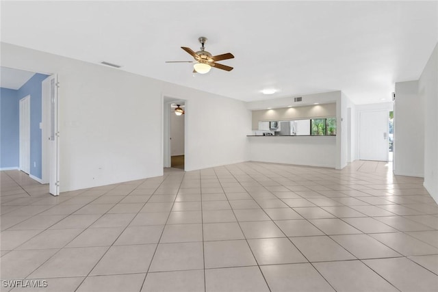 unfurnished living room featuring light tile patterned floors, visible vents, and a ceiling fan