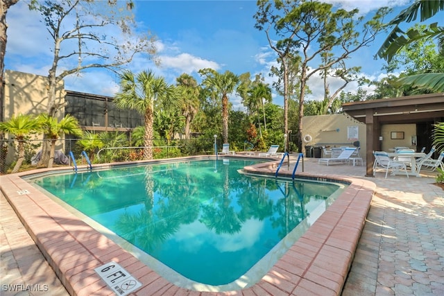 pool featuring a patio and fence