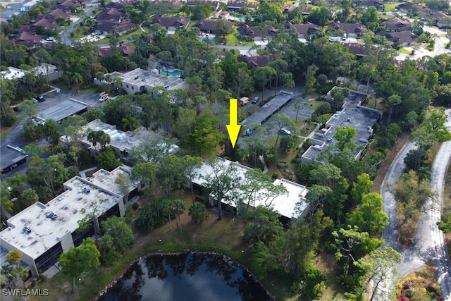 drone / aerial view featuring a residential view and a water view