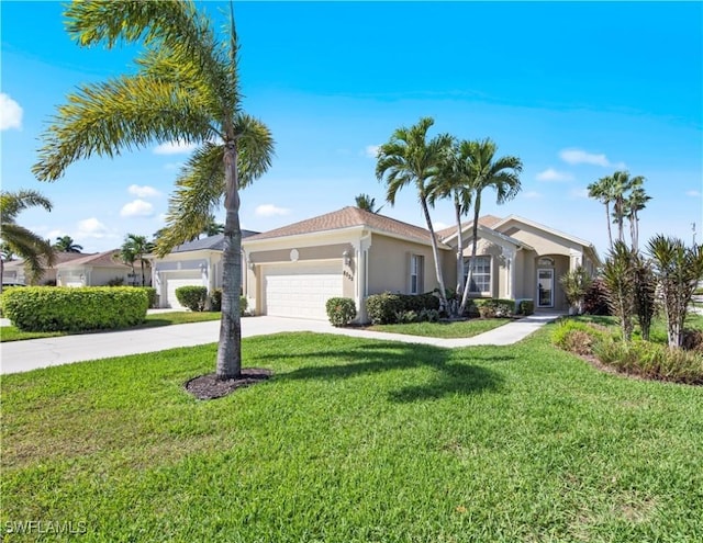 view of front of home with stucco siding, an attached garage, driveway, and a front yard