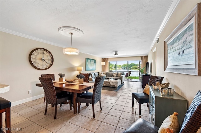 dining room with a textured ceiling, light tile patterned floors, visible vents, baseboards, and crown molding