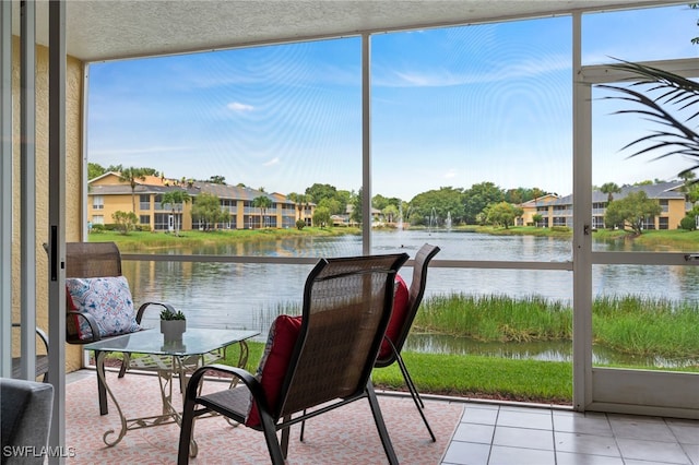 sunroom / solarium featuring a water view