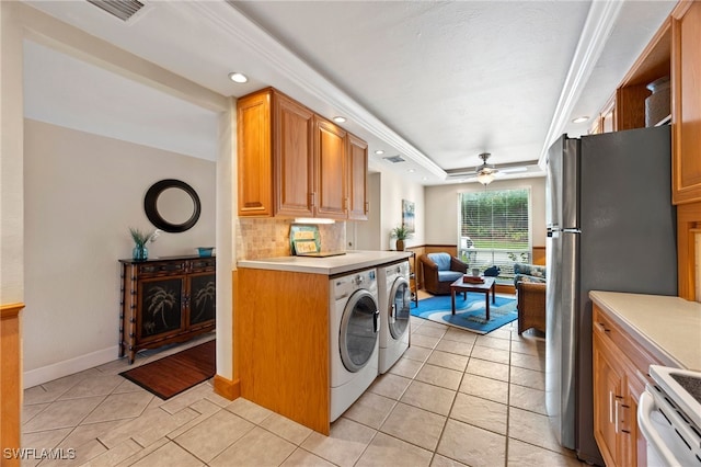 kitchen featuring light tile patterned floors, a raised ceiling, light countertops, a ceiling fan, and open floor plan