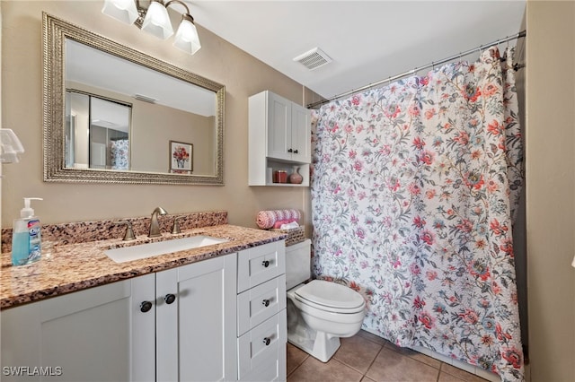 bathroom featuring visible vents, toilet, a shower with curtain, tile patterned flooring, and vanity