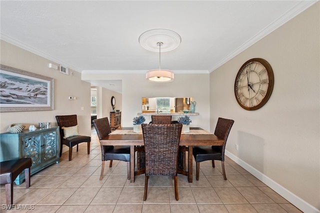 dining area featuring light tile patterned flooring, crown molding, visible vents, and baseboards