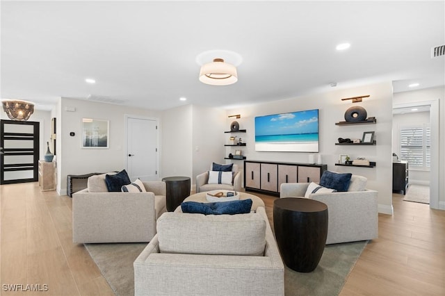 living area featuring visible vents, recessed lighting, and light wood-style floors