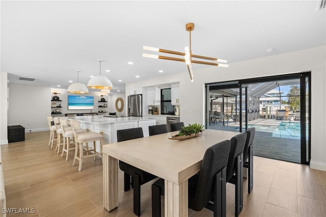 dining area featuring light wood finished floors, visible vents, recessed lighting, and baseboards