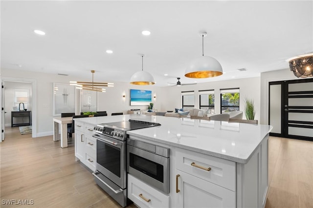 kitchen featuring visible vents, recessed lighting, stainless steel appliances, light wood-style floors, and white cabinetry