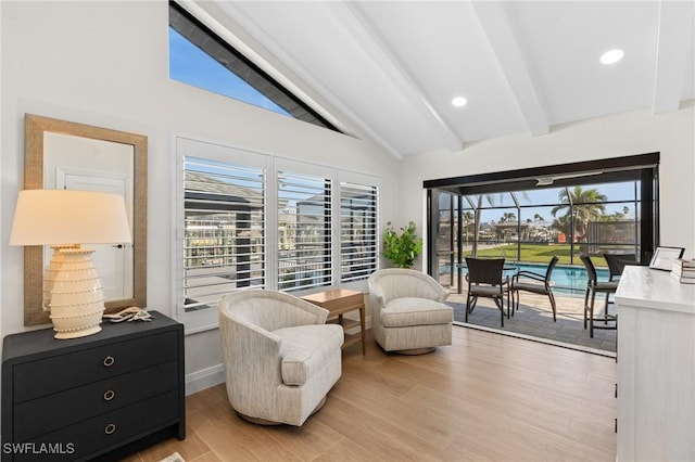 living area featuring vaulted ceiling with beams, recessed lighting, light wood-type flooring, and baseboards