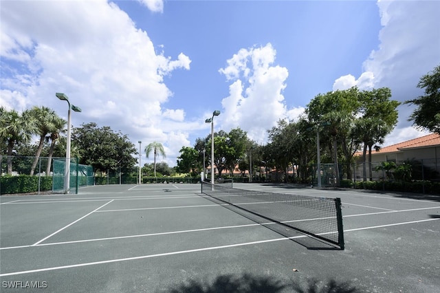 view of sport court featuring fence