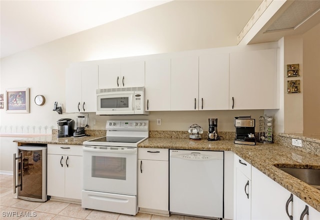 kitchen featuring white appliances, wine cooler, white cabinetry, and light stone countertops