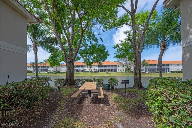 view of yard with a residential view and a water view