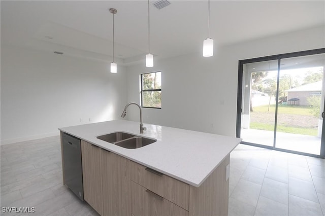 kitchen featuring light brown cabinetry, a sink, an island with sink, modern cabinets, and dishwashing machine