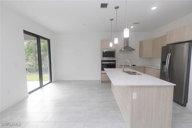 kitchen featuring visible vents, modern cabinets, stainless steel appliances, light countertops, and light brown cabinets