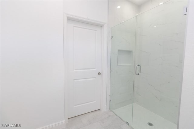 full bath with a marble finish shower