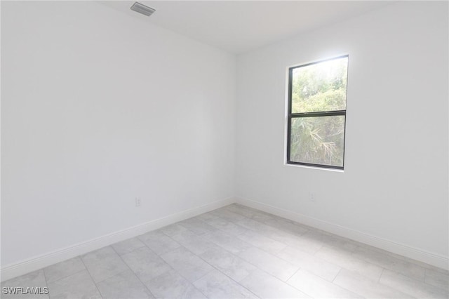 spare room with visible vents and baseboards