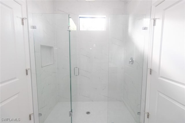 full bath with a marble finish shower