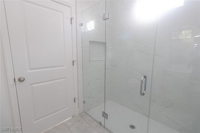 bathroom with a marble finish shower