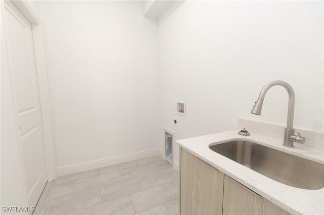 laundry room with washer hookup, cabinet space, a sink, electric dryer hookup, and baseboards