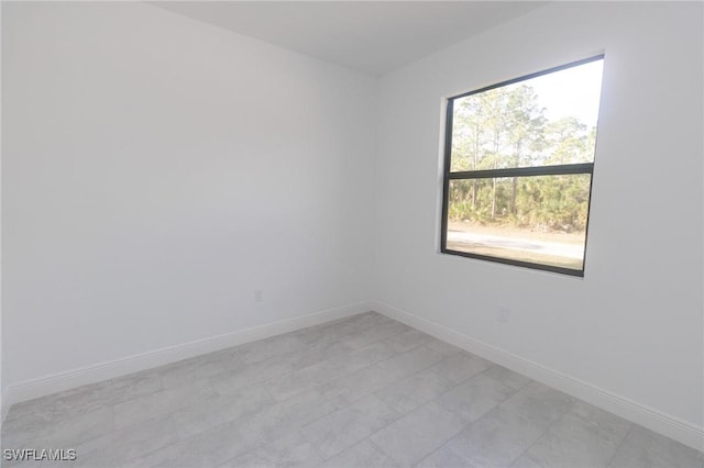 unfurnished room featuring baseboards