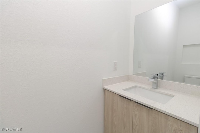 bathroom with vanity and toilet