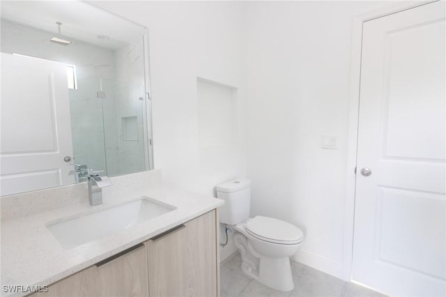 bathroom with a marble finish shower, baseboards, vanity, and toilet