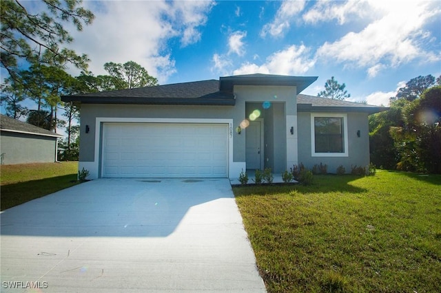 view of front of property featuring a garage, driveway, a front lawn, and stucco siding