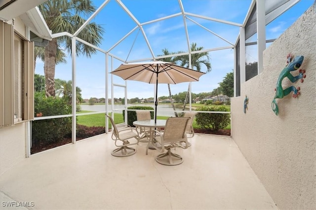 sunroom / solarium featuring a healthy amount of sunlight and a water view