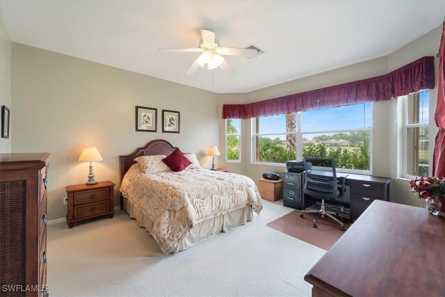 bedroom with ceiling fan, baseboards, visible vents, and light carpet