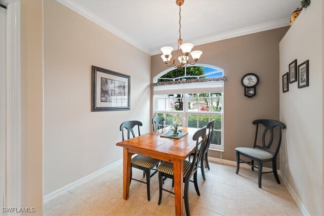 dining area with light tile patterned floors, baseboards, a notable chandelier, and crown molding