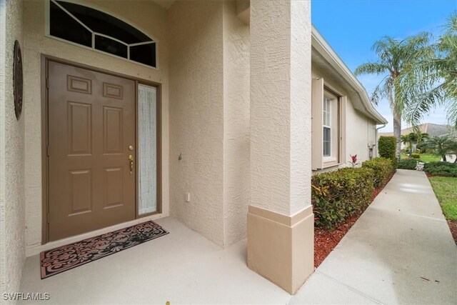 property entrance with stucco siding